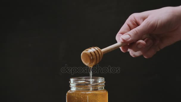 Person dipping honey stick in honey - Footage, Video