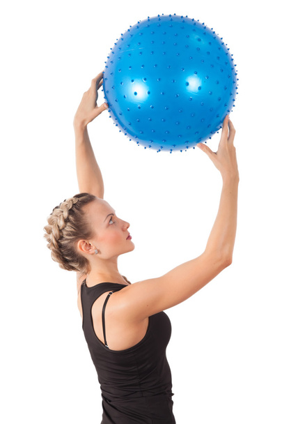 Athletic young woman with blue ball - Фото, зображення