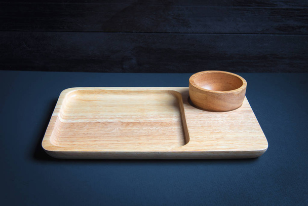 Wood plate on wooden table over grunge background - 写真・画像