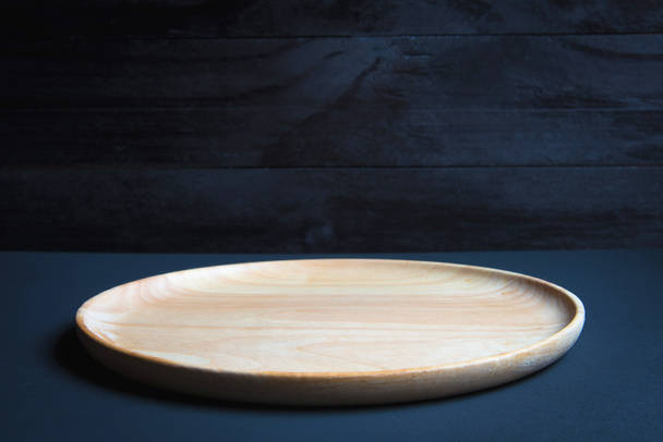 Wood plate on wooden table over grunge background - Foto, Imagen