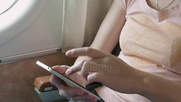 Airplane passenger scrolling through smart phone - Footage, Video