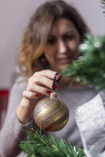 Picture of woman decorating christmas tree - Fotografie, Obrázek