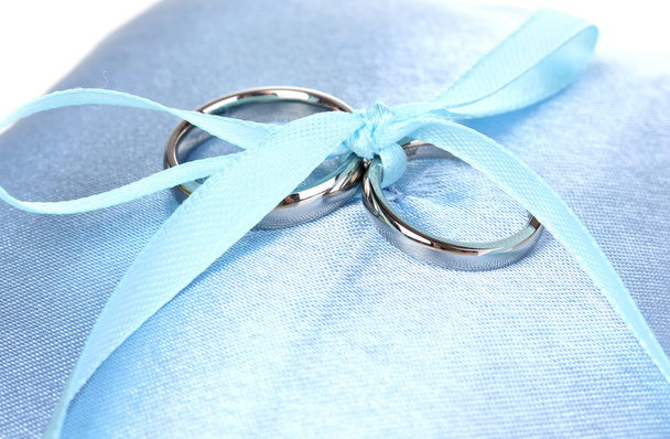 Wedding rings on satin pillow close-up - Fotoğraf, Görsel