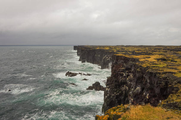 Atlantic ocean and black rock cliff of western Iceland coast, Snaefellsnes Peninsula, Iceland - Photo, Image