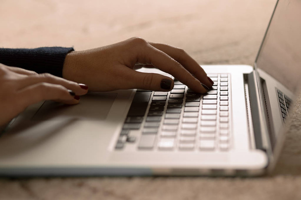 Closeup of a woman's hand working on laptop - Φωτογραφία, εικόνα