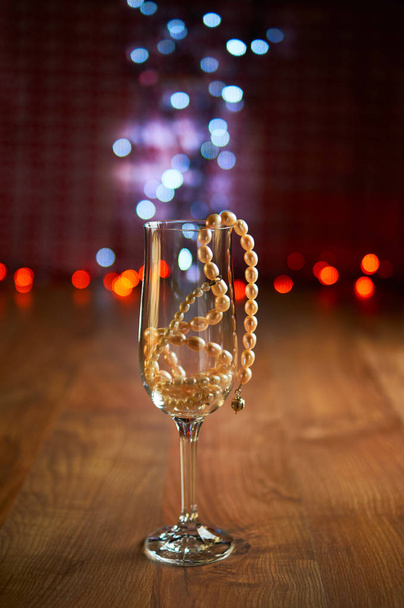 Glass of champagne and beads - Photo, Image