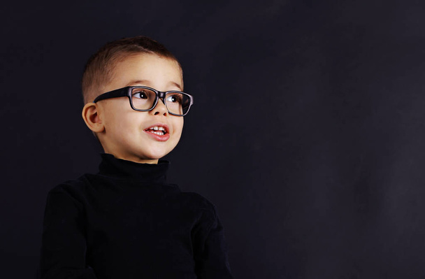 Portrait of happy child in pullover and glasses - Fotó, kép