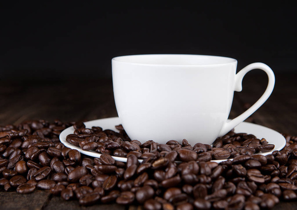 Hot coffee cup on beans for breakfast morning - Fotoğraf, Görsel