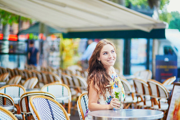 Woman in Parisian cafe with cocktail on a summer day - Foto, immagini