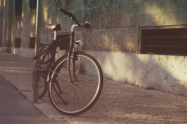 Bicycle parked on a street - Фото, зображення