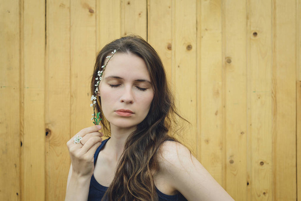 branches spirea on head young woman - Photo, Image