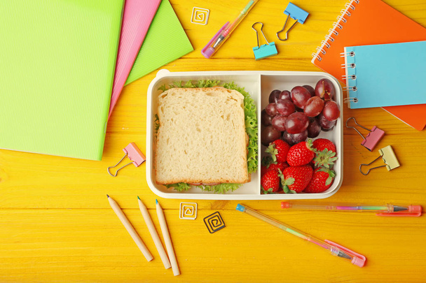 Lunchbox with tasty meal and stationery - Φωτογραφία, εικόνα