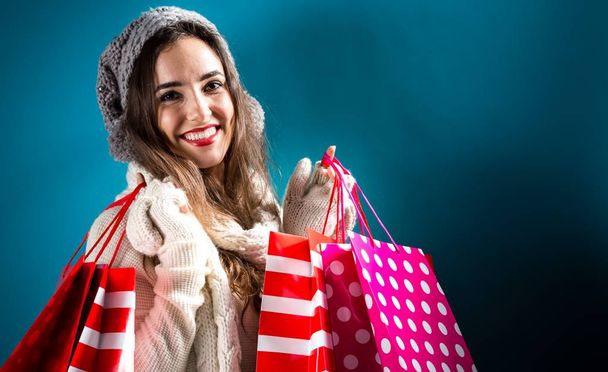 Happy young woman holding shopping bags - Fotoğraf, Görsel