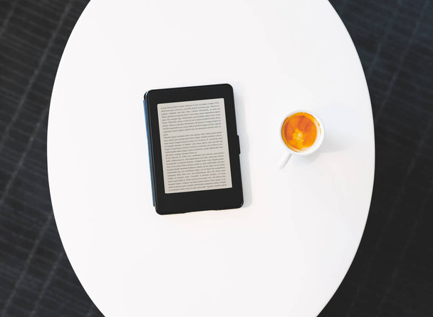 Top down view of digital e-reader with coffee - 写真・画像