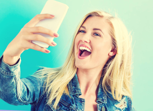 Young woman taking a selfie - Zdjęcie, obraz