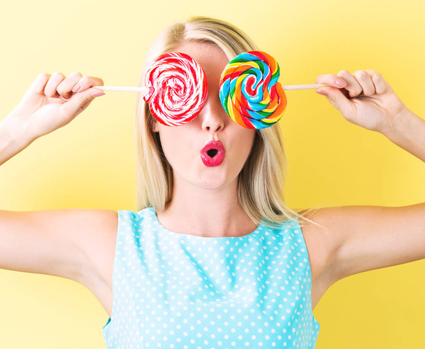 Young woman holding lollipops - Photo, Image