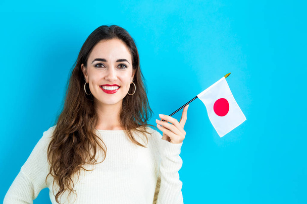 Young woman holding Japanese flag - Photo, image