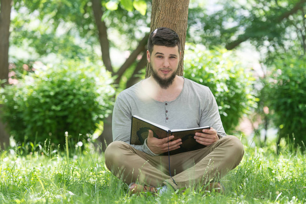 Muslim Man Is Reading The Koran In Park - Photo, image
