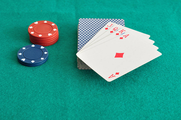 Red and blue poker chips with a deck of cards  - Φωτογραφία, εικόνα