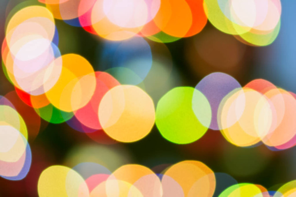Out of focus decorated Christmas tree lit by colored lights - Φωτογραφία, εικόνα