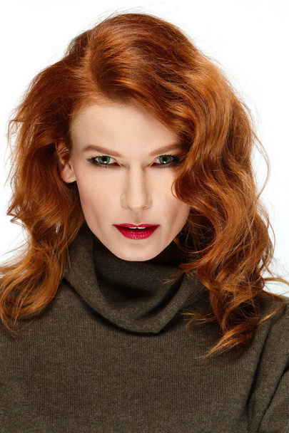 Pretty fashion model with red hair, lips and green eyes posing.  - Фото, зображення