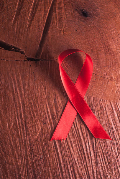 red ribbon on the wooden background - Photo, Image