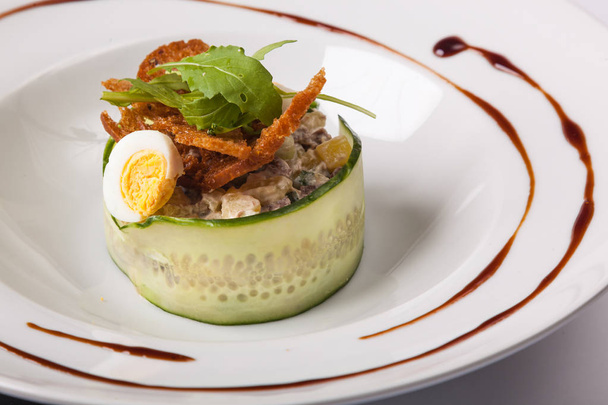 Russian salad with mayonnaise and egg on white plate - Photo, Image