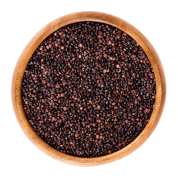 Sementes de quinoa preta em tigela de madeira sobre branco
 - Foto, Imagem