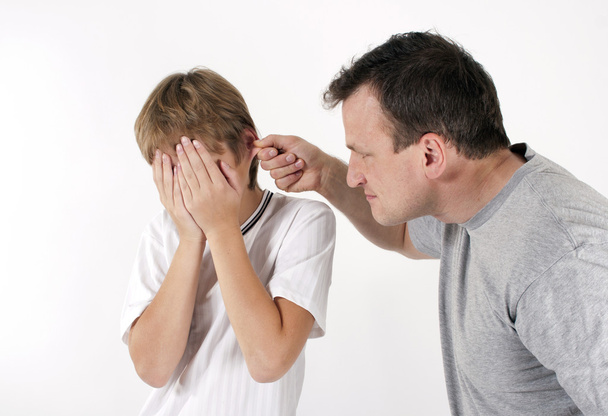 Strict father punishes his son. Isolated on white background - Photo, Image