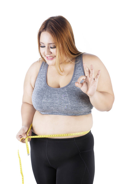 Fat woman doing measurement  - Foto, imagen