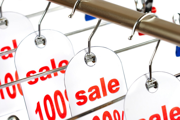 Sale. A hanger with labels on a white ba - Foto, imagen