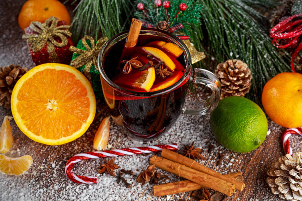 Hot Mulled wine with cinnamon sticks, orange, lime. christmas concept. - Fotoğraf, Görsel