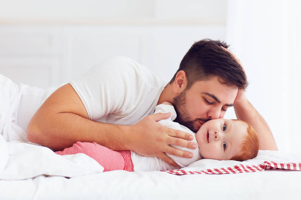 happy father playing with adorable baby in bedroom - Zdjęcie, obraz