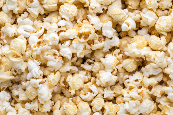 Popcorn background. Caramel sweet corn. Cinema snack. - Fotó, kép