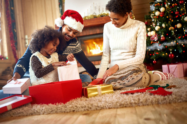 afro American parents with daughter opens Christmas presents - Fotó, kép