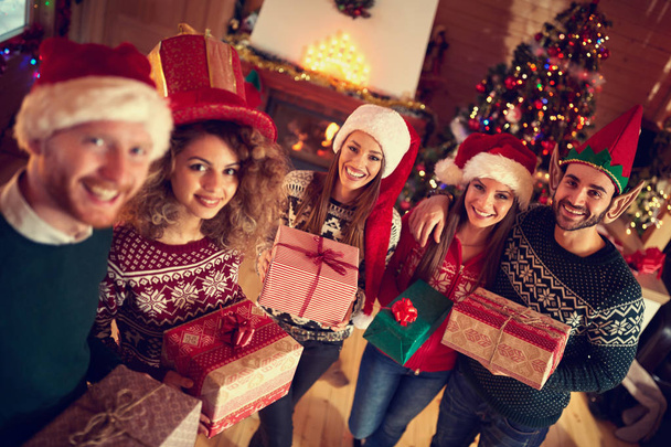 Young people on Christmas with gifts - Foto, Imagen