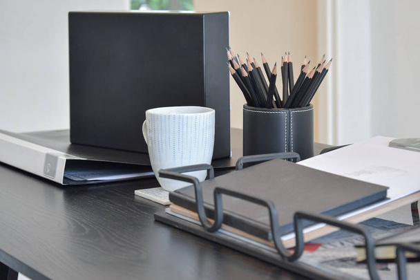work table with book,pencils and cup of coffee and in a home - Foto, Bild