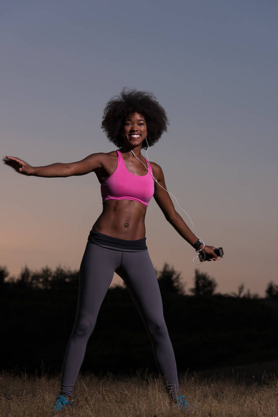black woman is doing stretching exercise relaxing and warm up - 写真・画像