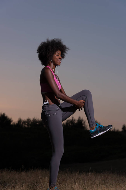 black woman is doing stretching exercise relaxing and warm up - Photo, Image