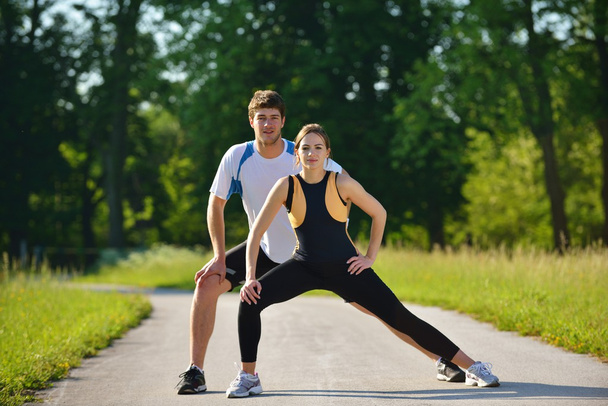 Couple doing stretching exercise after jogging - Fotoğraf, Görsel