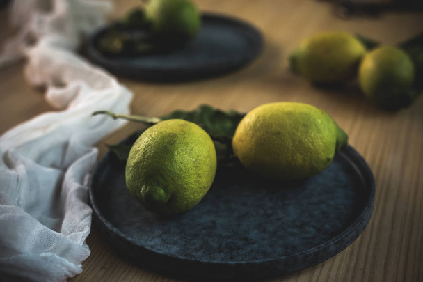 Fresh ripe citrus. Lemons, limes on dark background - Foto, immagini