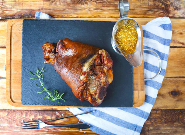 Roasted pork leg (rulka) served on the wooden table - Photo, Image
