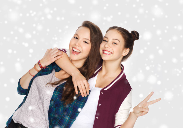 happy teenage girls hugging and showing peace sign - Photo, image