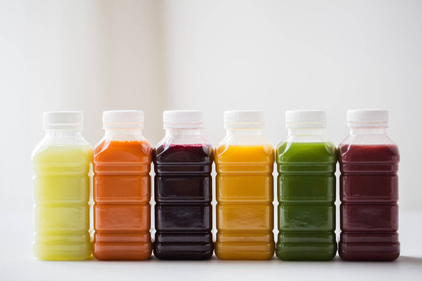 bottles with different fruit or vegetable juices - Foto, Imagem