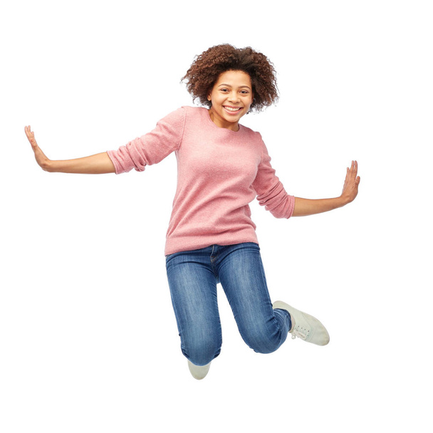 happy african american woman jumping over white - Fotoğraf, Görsel