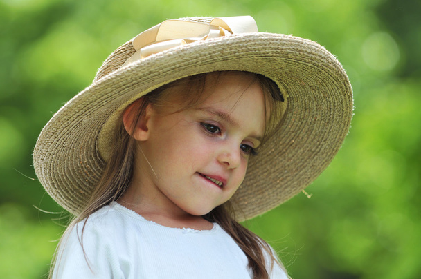 Little girl wearing a hat outdoors - Zdjęcie, obraz