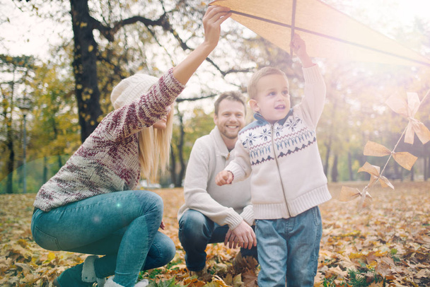 Happy Caucasian parents and his son enjoying outdoor - Фото, изображение