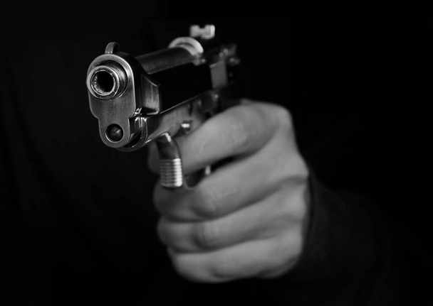 Man holding metal gun - Foto, imagen