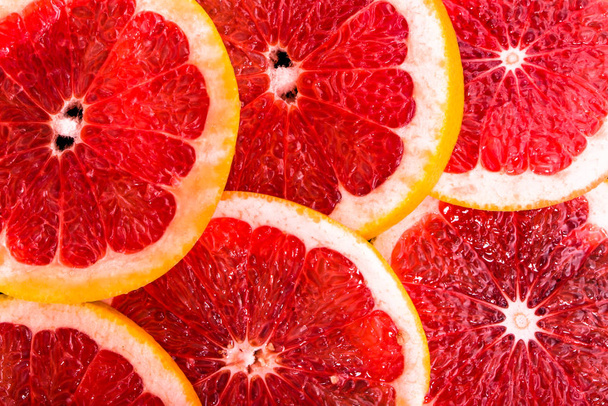 Macro of grapefruit slices, texture of citrus, close up, overhead view - Fotografie, Obrázek