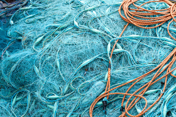 Pile of blue fishing nets Pile of blue fishing nets - Fotó, kép